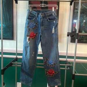 Carmar high waisted jeans with floral appliqué and studs.